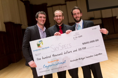 The three SkySpecs founders holding the giant $500,000 Accelerate Michigan Innovation Competition grand-prize check, November 2014